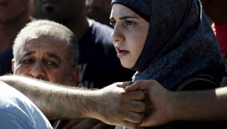  Migrants hold hands as they try to enter Macedonia near Gevgelija at the border with Greece September 2, 2015. Reuters/Ognen Teofilovski
