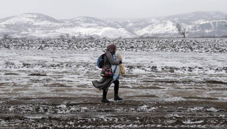 Reuters / Monday, January 18, 2016  A migrant walks through a frozen field after crossing the border from Macedonia, near the village of Miratovac, Serbia, January 18, 2016. REUTERS/Marko Djurica